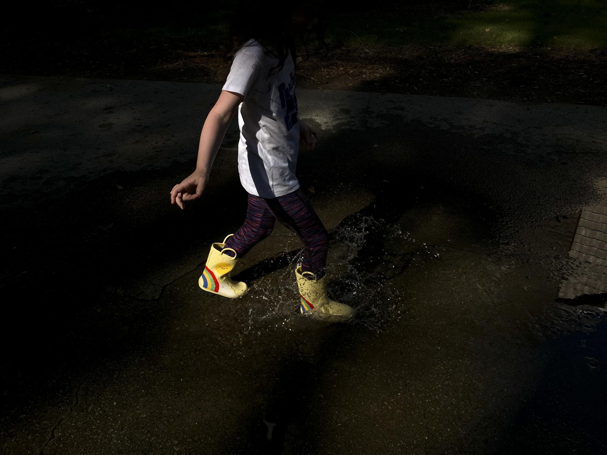 A child splashes in a puddle to beat the summer heat in Doraville, Ga. in this Wednesday, June, 15, 2022 iPhone photo. (Photo: Brynn Anderson/AP)