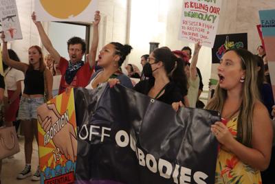 A group gathers to protest a sweeping abortion ban bill making its way through the West Virginia Legislature at the state Capitol on Wednesday, July 27, 2022 in Charleston, W.Va. (AP Photo/Leah Willingham)