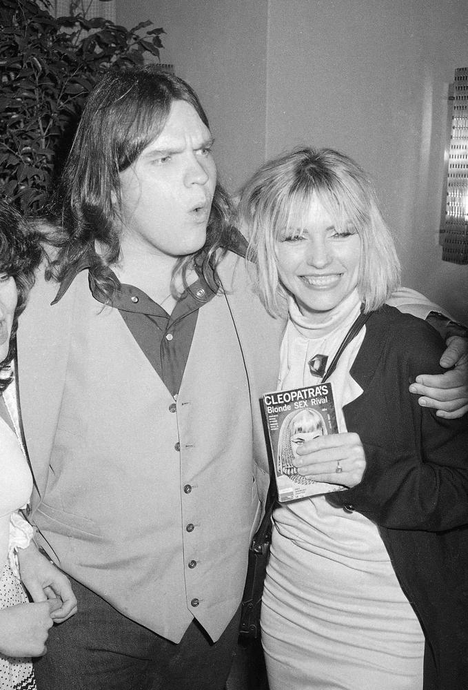 FILE - Rock star Meat Loaf is photographed with Blondie lead singer Deborah Harry at the party for the premiere of the movie "Roadie", June 12, 1980 in New York. Meat Loaf, the rock superstar loved by millions for his “Bat Out of Hell” album and for such theatrical, dark-hearted anthems as “Paradise by the Dashboard Light” and “Two Out of Three Ain’t Bad,” has died at age 74. A family statement on his official Facebook page says the singer born Marvin Lee Aday died Thursday night, Jan. 20, 2022. “Bat Out of a Hell,” his mega-selling collaboration with songwriter Jim Steinman, came out in 1977 and became one of the bestselling records in history. (AP Photo/G. Paul Burnett, File)