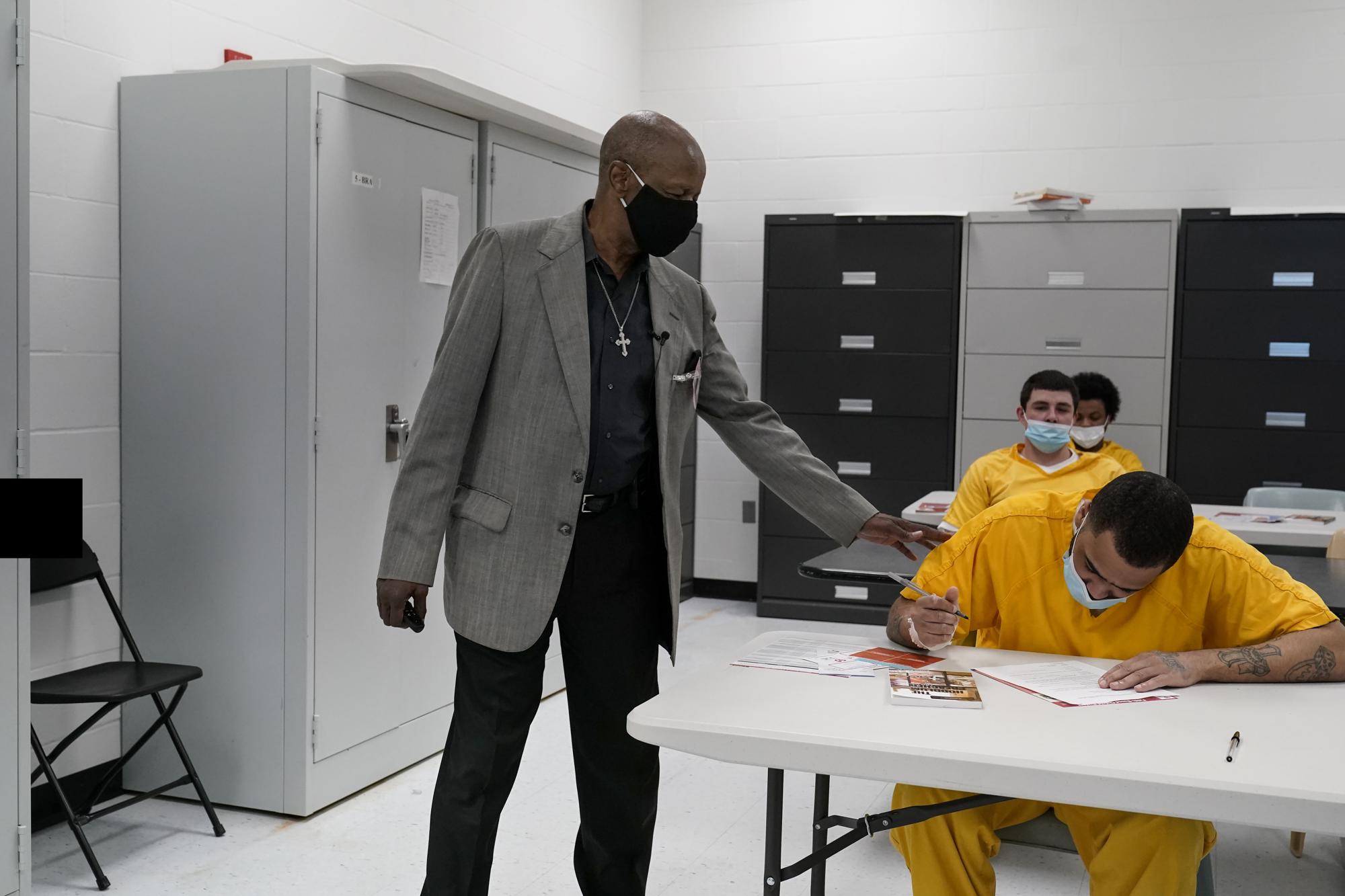 The Rev. Burton Barr works with inmates at the St. Louis City Justice Center on Thursday, May 20, 2021. He calls himself “the hoodlum preacher” and he goes to the jail twice a week to try to save people from the addiction that consumed his life for 22 years. The face of addiction then was inner-city Black people like him, and they were criminalized. Barr once tried to tally the number of times he went to jail, and he stopped counting at 30. (AP Photo/Brynn Anderson)