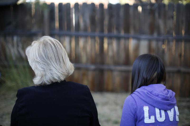 MJ and her adoptive mother sit for an interview with The Associated Press in Sierra Vista Ariz Oct 27 2021 State authorities placed MJ in foster care after learning that her father the late Paul Adams sexually assaulted her and posted video of the assaults on the Internet AP PhotoDario Lopez-Mills