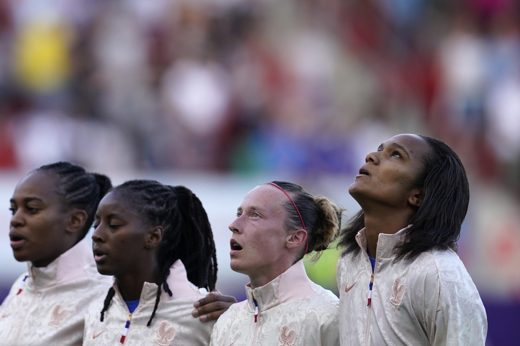 FILE - France's team captain Wendie Renard, right, stands with her teammates during the national anthems before the Women Euro 2022 group D soccer match between France and Italy at New York Stadium in Rotherham, England, Sunday, July 10, 2022. (AP Photo/Dave Thompson, File)