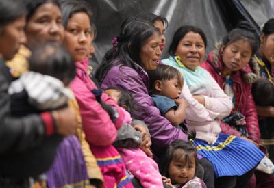 Mujeres y niños indígenas se reúnen dentro del Parque Nacional de Bogotá, donde cientos han estado acampando alrededor de una semana, en Colombia, el jueves 7 de octubre de 2021. Indígenas de diferentes partes del país están esperando que el gobierno les garantice su regreso seguro a casa, a las aldeas que dejaron atrás debido a la violencia. (Foto AP/Fernando Vergara)