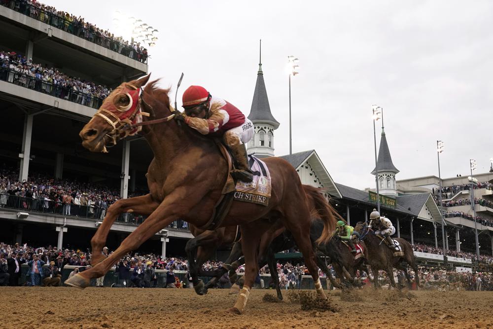 Rich Strike (21), with Sonny Leon aboard, wins the 148th running of the Kentucky Derby horse race at Churchill Downs Saturday, May 7, 2022, in Louisville, Ky. (AP Photo/Jeff Roberson)