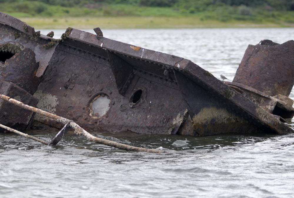 The wreckage of a WWII German warship is seen in the Danube river near Prahovo, Serbia, Monday, Aug. 29, 2022. The worst drought in Europe in decades has not only scorched farmland and hampered river traffic, it also has exposed a part of World War II history that had almost been forgotten. The hulks of dozens of German battleships have emerged from the mighty Danube River as its water levels dropped. (AP Photo/Darko Vojinovic)