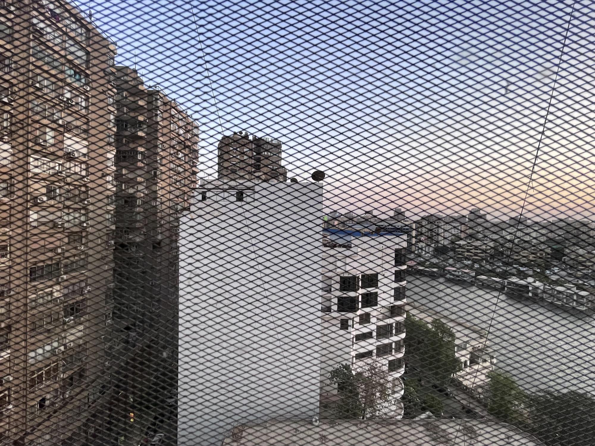 Residential buildings and a hotel overlook the Nile river, seen behind a wire mesh in Cairo, Egypt, in this Friday, June 17, 2022 - photo taken with an iPhone. (Photo: Nariman El-Mofty/AP)