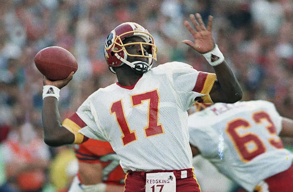 FILE - In this Jan. 31, 1988, file photo, Washington Redskins quarterback Doug Williams prepares to let go of a pass during first quarter of Super Bowl XXII against the Denver Broncos in San Diego. Brock Purdy's bid to join the select group of quarterbacks to go from a backup for most of the season to a Super Bowl starter got derailed when he suffered his own injury in the NFC championship game. There have been several examples of backups leading a team to the big game. (AP Photo/Elise Amendola, File)
