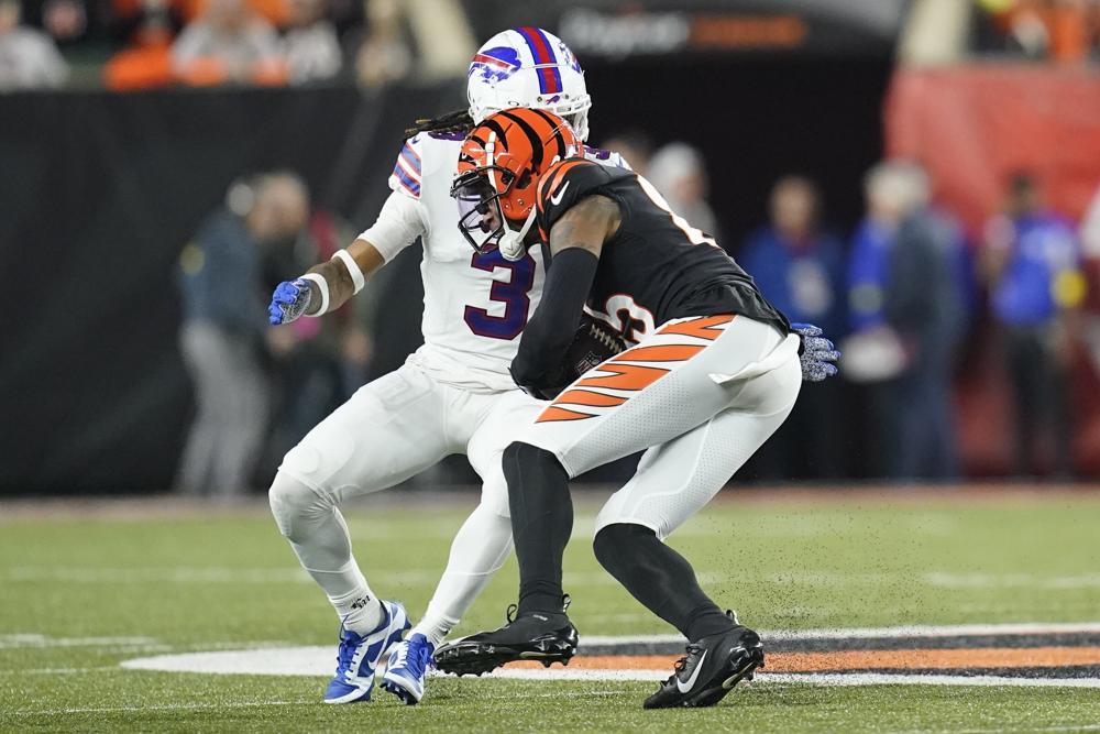 Cincinnati Bengals wide receiver Tee Higgins (85) runs near Buffalo Bills safety Damar Hamlin (3) during the first half of an NFL football game, Monday, Jan. 2, 2023, in Cincinnati. Hamlin was injured on the play. The game has been postponed after Buffalo Bills' Damar Hamlin collapsed, NFL Commissioner Roger Goodell announced. (AP Photo/Joshua A. Bickel)