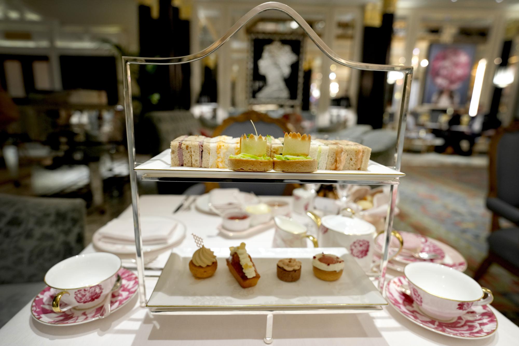 A Coronation themed tea is displayed at The Dorchester Hotel in London, Thursday, April 20, 2023. The Dorchester Hotel, long a favorite with royals and celebrities, concocted a lavish, five-tier coronation cake and put up theater-style draping across its facade to re-create the decorations that it used to mark Queen Elizabeth II’s coronation in 1953 in preparation for King Charles III's coronation on May 6. (AP Photo/Kirsty Wigglesworth)