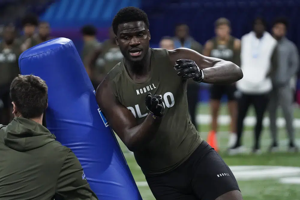 FILE - LSU defensive lineman Ali Gaye runs a drill at the NFL football scouting combine in Indianapolis, Thursday, March 2, 2023. Former LSU defensive lineman Ali Gaye’s father was prompted to come to America for better medical care and now Gaye is on the verge of becoming the first Gambian-born NFL player. (AP Photo/Erin Hoole, File)