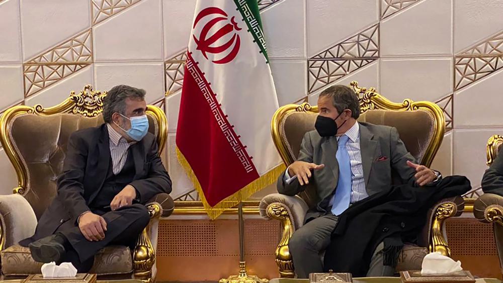 FILE - Director General of International Atomic Energy Agency, IAEA, Rafael Mariano Grossi, right, speaks with deputy head of the Atomic Energy Organization of Iran Behrouz Kamalvandi at Imam Khomeini Airport, in Tehran, Iran, Nov. 22, 2021. Iran announced Sunday, July 10, 2022, that it has begun enriching uranium up to 20% using sophisticated centrifuges at its underground Fordo nuclear plant, state TV reported, an escalation that comes amid a standoff with the West over its tattered atomic deal. Kamalvandi said uranium enriched to 20% was collected for the first time from advanced IR-6 centrifuges on Saturday. (Atomic Energy Organization of Iran via AP, File)