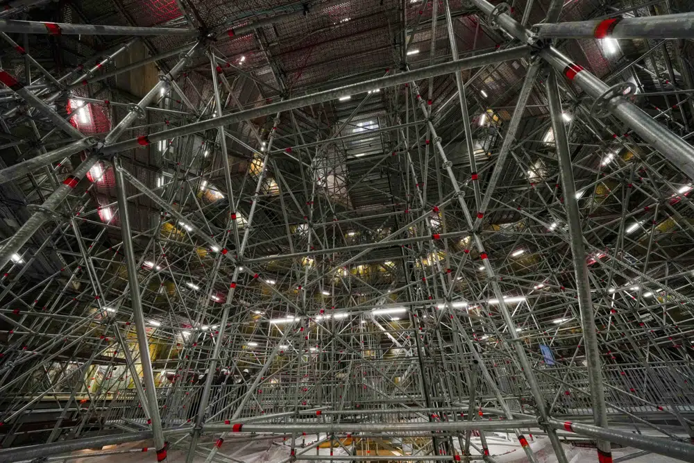 Scaffolding inside the dome of St. John's Baptistery, one of the oldest churches in Florence, central Italy, Tuesday, Feb. 7, 2023. The Baptistery's dome is undergoing a restoration work that will be done from an innovative scaffolding shaped like a giant mushroom that will stand for the next six years in the center of the church, and that will be open to visitors allowing them for the first and perhaps only time, to come come face to face with more than 1,000 square meters of precious mosaics covering the dome. (AP Photo/Andrew Medichini)