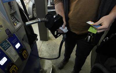 A customer prepares to pump gasoline into his car at a Sam's Club fuel island in Gulfport, Miss., Feb. 19, 2022. The Russia-Ukraine crisis is helping to raise oil and gasoline prices to high levels. Gasoline prices are setting a new record, and they're likely to go higher in the coming weeks. The national average topped $4.17 a gallon on Tuesday, March 8 according to auto club AAA. Californians already pay over $5 on average, and residents in a few other states could soon join them.  (AP Photo/Rogelio V. Solis)