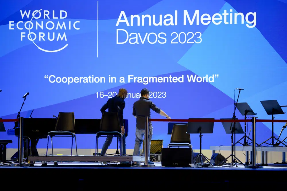 As elites arrive in Davos, conspiracy theories thrive online