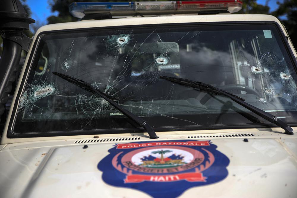 Bullet holes cover the windshield of a police car in Petion-ville, Haiti, Wednesday, Jan. 25, 2023. At a time when democracy has withered in Haiti and gang violence has spiraled out of control, armed men are filling in the power vacuum left by a crumbling government. (AP Photo/Odelyn Joseph)