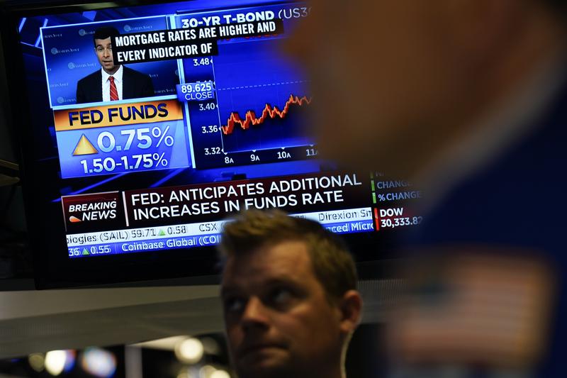 As the Federal Reserve announces a rate change, traders work on the floor at the New York Stock Exchange in New York, Wednesday, June 15, 2022. The Federal Reserve intensified its drive to tame high inflation by raising its key interest rate by three-quarters of a point — its largest hike in nearly three decades — and signaling more large rate increases to come that would raise the risk of another recession. (AP Photo/Seth Wenig)