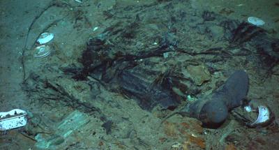 FILE - This 2004 photo provided by the Institute for Exploration, Center for Archaeological Oceanography/University of Rhode Island/NOAA Office of Ocean Exploration, shows the remains of a coat and boots in the mud on the sea bed near the Titanic's stern. A search is underway for a missing submersible that carries people to view the wreckage of the Titanic, according to media reports. The U.S. Coast Guard told BBC News that a search was underway Monday, June 19, 2023, off the coast of Newfoundland. (Institute for Exploration, Center for Archaeological Oceanography/University of Rhode Island/NOAA Office of Ocean Exploration, File)