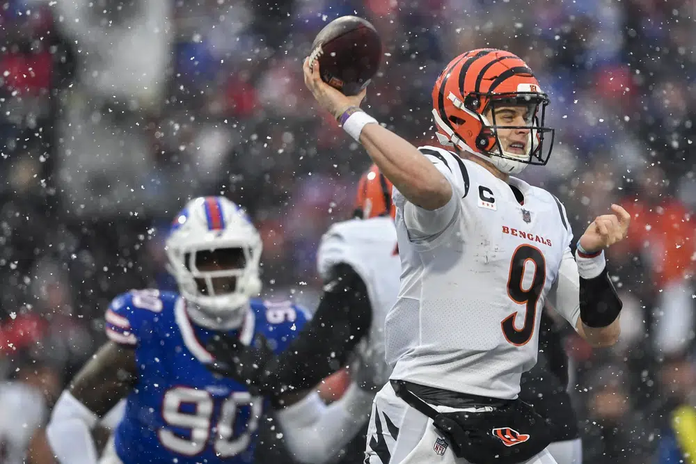 Cincinnati Bengals quarterback Joe Burrow (9) passes against the Buffalo Bills during the second quarter of an NFL division round football game, Sunday, Jan. 22, 2023, in Orchard Park, N.Y. (AP Photo/Adrian Kraus)