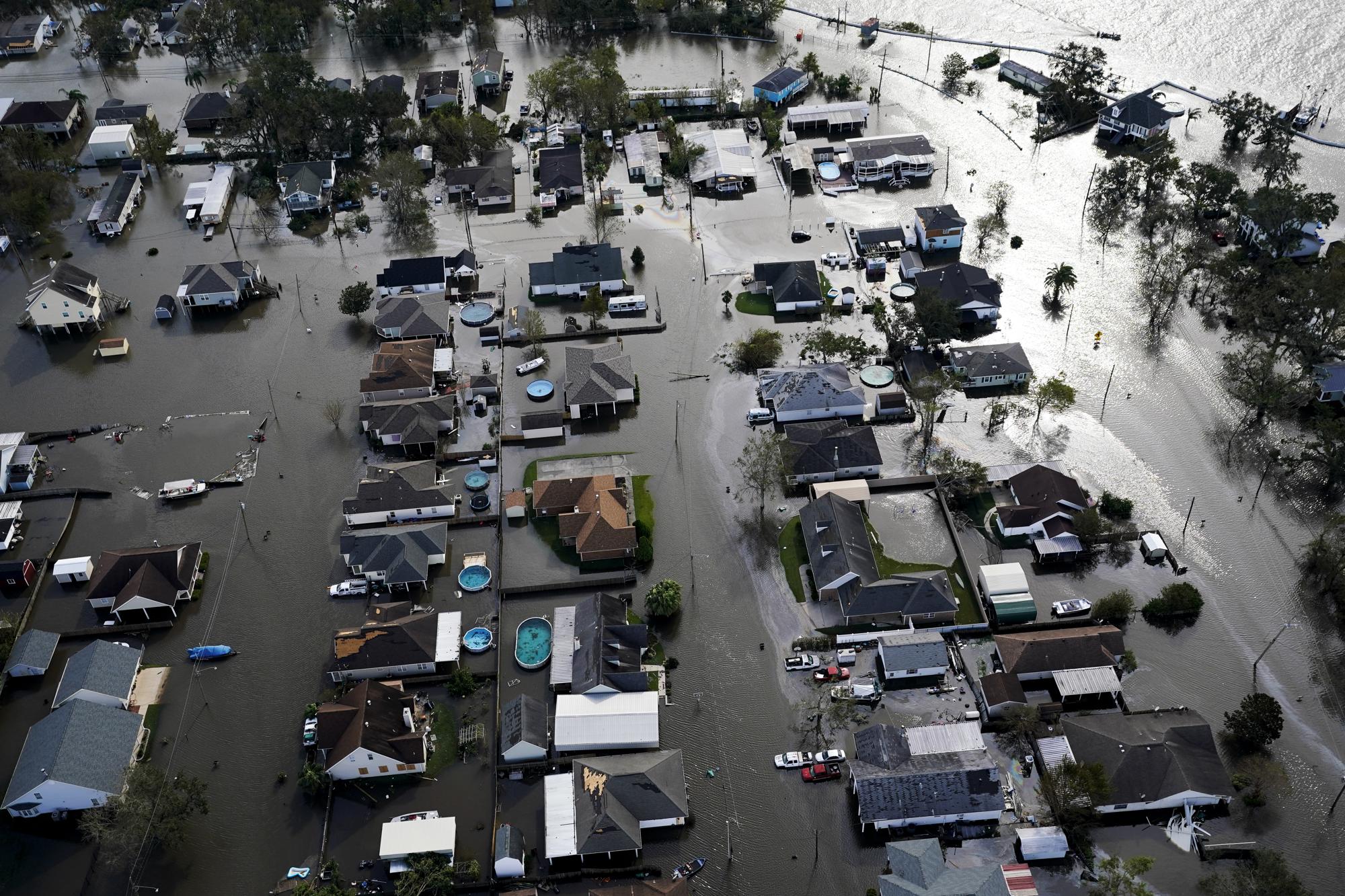 FILE - Homes are flooded in the aftermath of Hurricane Ida, Monday, Aug. 30, 2021, in Jean Lafitte, La. The United Nations on Monday, Feb. 28, 2022, released a new report on climate change. (AP Photo/David J. Phillip, File)