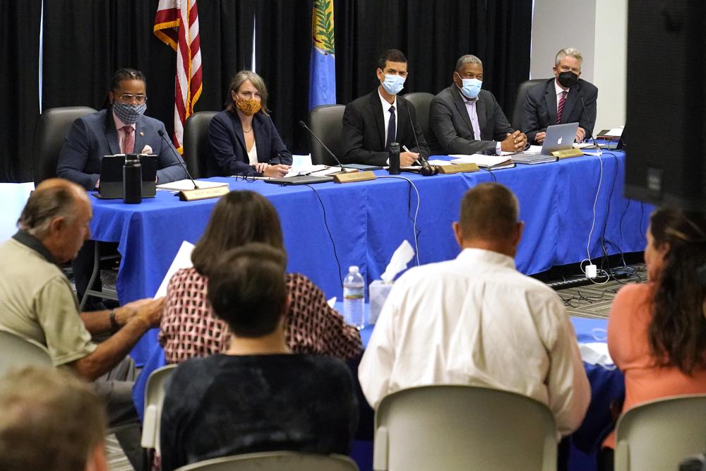 FILE - The Oklahoma Pardon and Parole Board, from left, Scott Williams, Kelly Doyle, Adam Luck, Larry Morris and Richard Smotherman, listen as the family of Paul Howell testifies at a commutation hearing for Julius Jones, in Oklahoma City on Sept. 13, 2021. Luck, the chairman of the Oklahoma Pardon and Parole Board who has consistently voted to spare the lives of death row inmates is resigning at the request of the governor. (AP Photo/Sue Ogrocki, File)