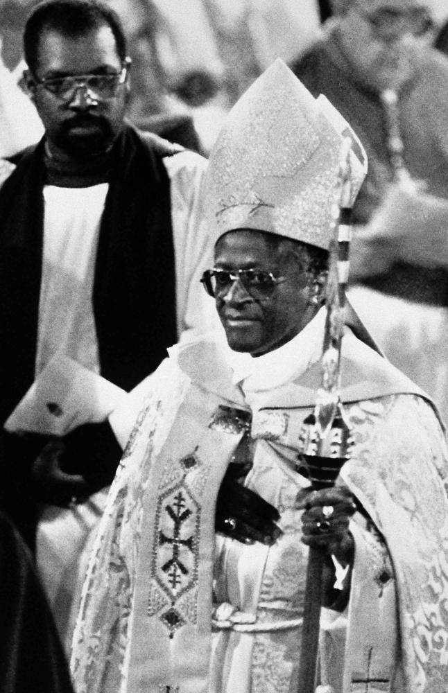 FILE - Archbishop Desmond Tutu stands during his enthronement service at St. Georges Cathedral, in Cape Town, South Africa, Sept. 7, 1986. Tutu, South Africa’s Nobel Peace Prize-winning activist for racial justice and LGBT rights and retired Anglican Archbishop of Cape Town, has died, South African President Cyril Ramaphosa announced Sunday Dec. 26, 2021. He was 90. (AP Photo/Greg English, File)