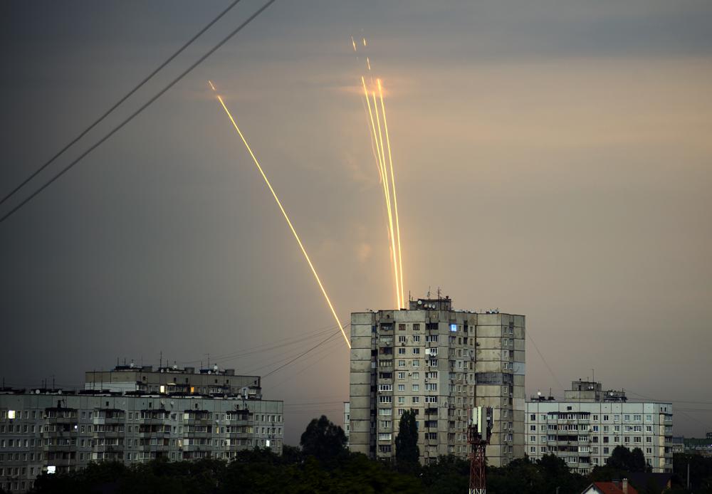 FILE - Russian rockets are launched against Ukraine from Russia's Belgorod region at dawn in Kharkiv, Ukraine, Aug. 15, 2022. Eight months after Russian President Vladimir Putin launched an invasion against Ukraine expecting a lightening victory, the war continues, affecting not just Ukraine but also exacerbating death and tension in Russia among its own citizens. (AP Photo/Vadim Belikov, File)