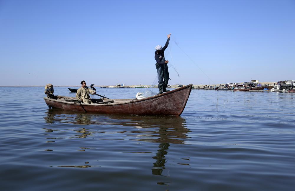 Fishermen pull n their nets in the salty waters of Razzaza Lake, also known as Lake Milh, Arabic for salt, in the Karbala governorate of Iraq, Feb. 14, 2022.  Feb. 14, 2022. Hundreds of families used to rely on fishing in the lake for their livelihood. Now the number of dead fish that turn up is bigger than the number of live fish they can catch. (AP Photo/Hadi Mizban)