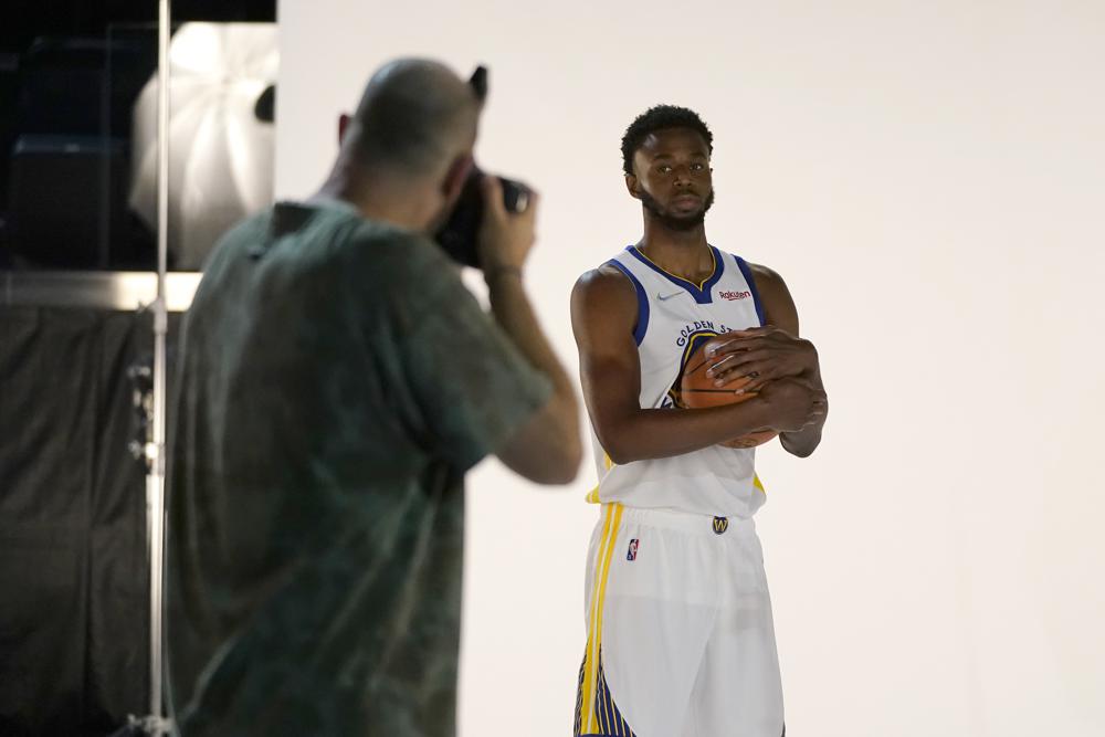 Golden State Warriors forward Andrew Wiggins, right, poses for photographer Noah Graham during the NBA basketball team's media day in San Francisco, Monday, Sept. 27, 2021. (AP Photo/Jeff Chiu)