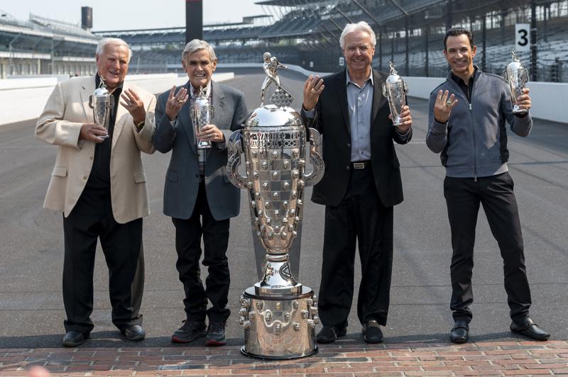 FILE - Winner of this year's Indy 500, Helio Castroneves, right, gathered with other four-time winners, from left, A.J. Foyt (1961, 1964, 1967, 1977), Al Unser (1970, 1971, 1978, 1987) and Rick Mears (1979, 1984, 1988, 1991) at the Indianapolis Motor Speedway in Indianapolis, Tuesday, July 20, 2021. Castroneves won the race in 2001, 2002, 2009 and 2021. Unser, one of only four drivers to win the Indianapolis 500 a record four times, died Thursday, Dec. 9, 2021, following years of health issues. He was 82. (AP Photo/Doug McSchooler, File)