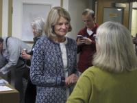 Alaska U.S. Sen. Lisa Murkowski, center, is shown at the grand opening of her reelection campaign office in Juneau, Alaska, on Thursday, Aug. 11, 2022. Murkowski said she expects to be among the candidates who will advance from the Aug. 16, 2022, U.S. Senate primary in Alaska. Under a system approved by voters and being used in Alaska for the first time this year, the top four vote-getters in the primary, regardless of party affiliation, will advance to the November general election, in which ranked voting will be used. (AP Photo/Becky Bohrer)