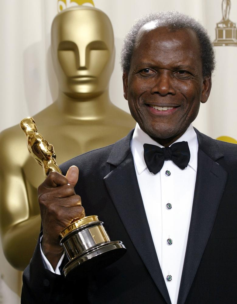 REMOVES REFERENCE TO THE BAHAMAS - FILE - Sidney Poitier poses with his honorary Oscar during the 74th annual Academy Awards on March 24, 2002, in Los Angeles.  Poitier, the groundbreaking actor and enduring inspiration who transformed how Black people were portrayed on screen, became the first Black actor to win an Academy Award for best lead performance and the first to be a top box-office draw, died Thursday, Jan. 6, 2022. He was 94. (AP Photo/Doug Mills, File)