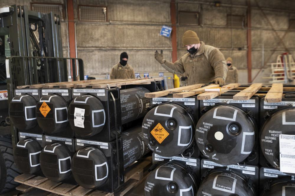 FILE - In this image provided by the U.S. Air Force, Airmen and civilians from the 436th Aerial Port Squadron palletize ammunition, weapons and other equipment bound for Ukraine during a foreign military sales mission at Dover Air Force Base, Del., on Jan. 21, 2022. The longer Ukraine's army fends off the invading Russians, the more it absorbs the advantages of Western weaponry and training. Military experts say that's exactly the transformation President Vladimir Putin wanted to prevent by invading Ukraine in the first place. (Mauricio Campino/U.S. Air Force via AP)