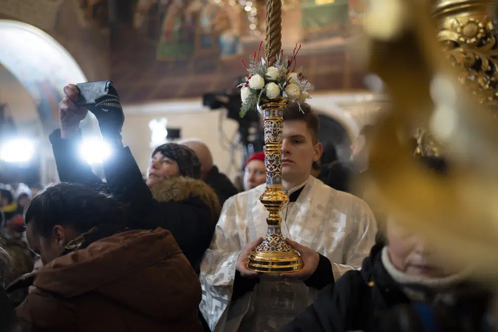 A priest holds a candle during an Orthodox Christmas service inside the nearly 1,000-year-old Pechersk Lavra Cathedral of Kyiv, Ukraine, Saturday, Jan. 7, 2023. Hundreds of Ukrainians heard the Orthodox Christmas service in the Ukrainian language for the first time at Kyiv’s 1,000-year-old Lavra Cathedral on Orthodox Christmas Day, a demonstration of independence from the Russian orthodox church. (AP Photo/Roman Hrytsyna)