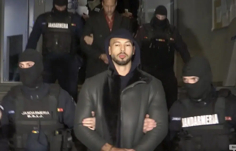In this grab taken from video released by Observator Antena 1, Social Media personality Andrew Tate is led away by police, in the Ilfov area, north of Bucharest, Romania, Thursday, Dec. 29, 2022. Romanian news outlets are reporting that divisive social media personality Andrew Tate has been arrested on charges of human trafficking and rape. The reports say Tate and his brother Tristan were detained late Thursday. Romania’s anti-organized crime agency said two British citizens and two Romanians are accused of being part of an organized crime group, human trafficking and rape. (Observator Antena 1 via AP)