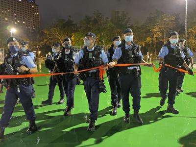 Agentes colocan un cordón policial tras el anuncio del cierre del Parque Victoria, donde solía celebrarse una vigilia, antes del 33er aniversario de la represión militar en la Plaza de Tiananmen de Beijing, en Hong Kong, el 3 de junio de 2022. (AP Foto/Rafael Wober)
