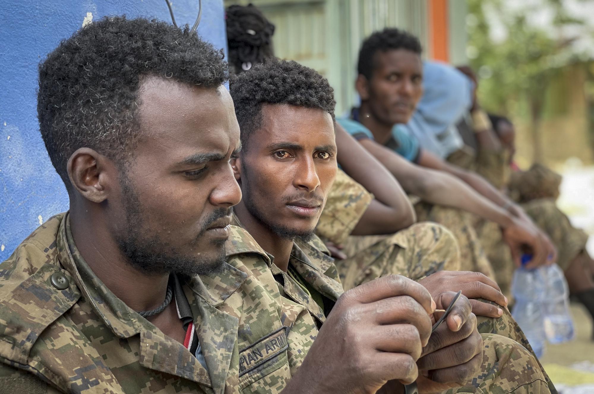 Members of the Ethiopian National Defense Force who were captured by Tigray forces sit inside a prison where they are now held as prisoners of war, in Mekele, in the Tigray region of northern Ethiopia on Tuesday, July 6, 2021. (AP Photo)