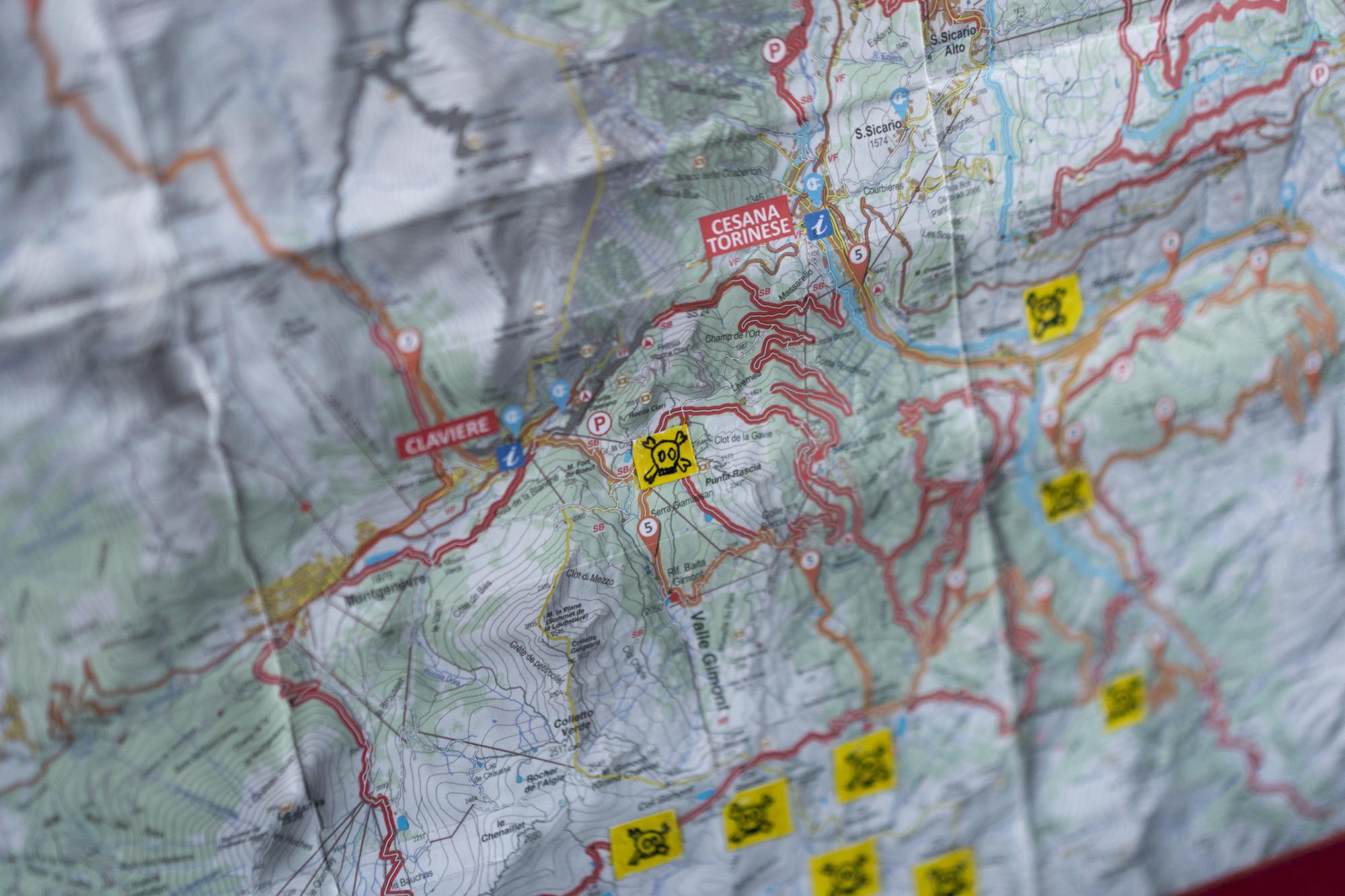 A map indicating dangerous routes for migrants traveling on foot is pictured at a migrant refuge in Oulx, Italy, Saturday, Dec. 11, 2021. (AP Photo/Daniel Cole)