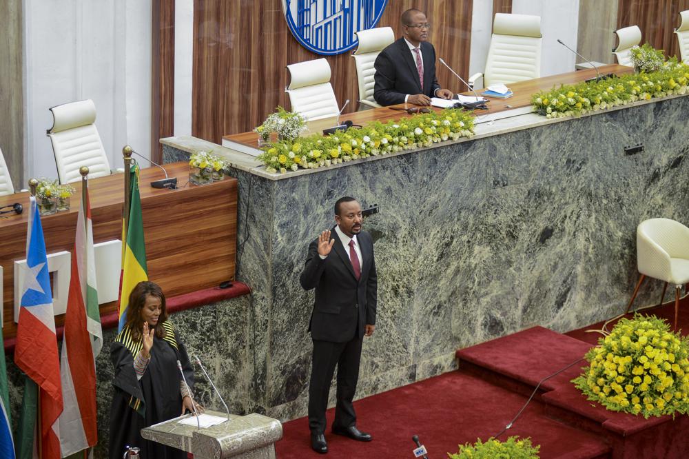 Ethiopia's Prime Minister Abiy Ahmed is sworn in for a second five-year term, at the House of Peoples Representatives in the capital Addis Ababa, Ethiopia Monday, Oct. 4, 2021. The prime minister, the 2019 Nobel Peace Prize winner for restoring ties with neighboring Eritrea and for pursuing sweeping political reforms, now faces major challenges as war in the Tigray region spreads into other parts of the country. (AP Photo)