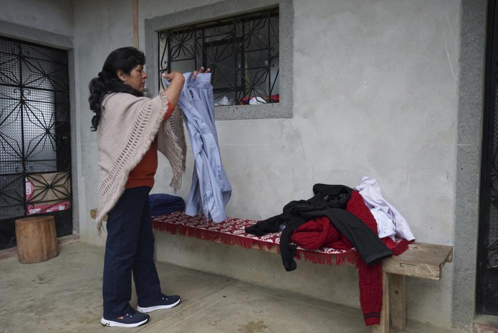 La futura primera dama de Perú, Lilia Paredes, de 48 años, dobla una camisa que pertenece a su esposo, el presidente electo Pedro Castillo, en el patio de su casa situada en el municipio de Chugur, Perú, el jueves 22 de julio de 2021. (AP Foto/Franklin Briceño)