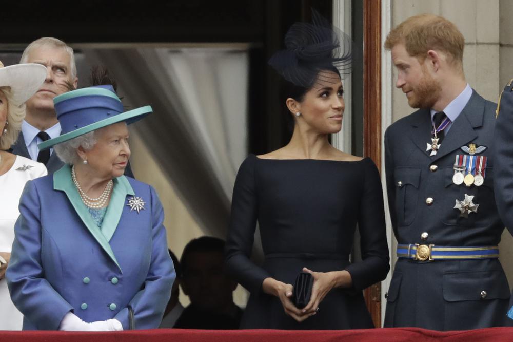 FILE - In this Tuesday, July 10, 2018 file photo Britain's Queen Elizabeth II, Meghan the Duchess of Sussex and Prince Harry stand on a balcony to watch a flypast of Royal Air Force aircraft pass over Buckingham Palace in London. The second baby for the Duke and Duchess of Sussex is officially here: Meghan gave birth to a healthy girl on Friday, June 4, 2021. A spokesperson for Prince Harry and Meghan said the couple welcomed their child Lilibet “Lili” Diana Mountbatten-Windsor. Their daughter weighed in at 7 lbs, 11 oz. Her first name, Lilibet, is a nod to Her Majesty The Queen's nickname. Her middle name is in honor of her grandmother and Harry's mother. The baby is the eighth in line to the British throne.   (AP Photo/Matt Dunham, File)