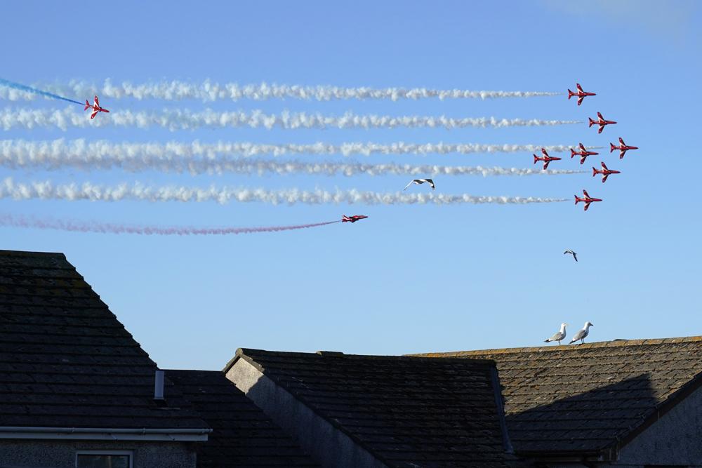 The Red Arrows flight demonstration team performs an aerobatic display above Carbis Bay, England, Saturday, June 12, 2021, during the G-7 summit. The Red Arrows, officially known as the Royal Air Force Aerobatic Team, is the aerobatics display team of the Royal Air Force. (AP Photo/Patrick Semansky)