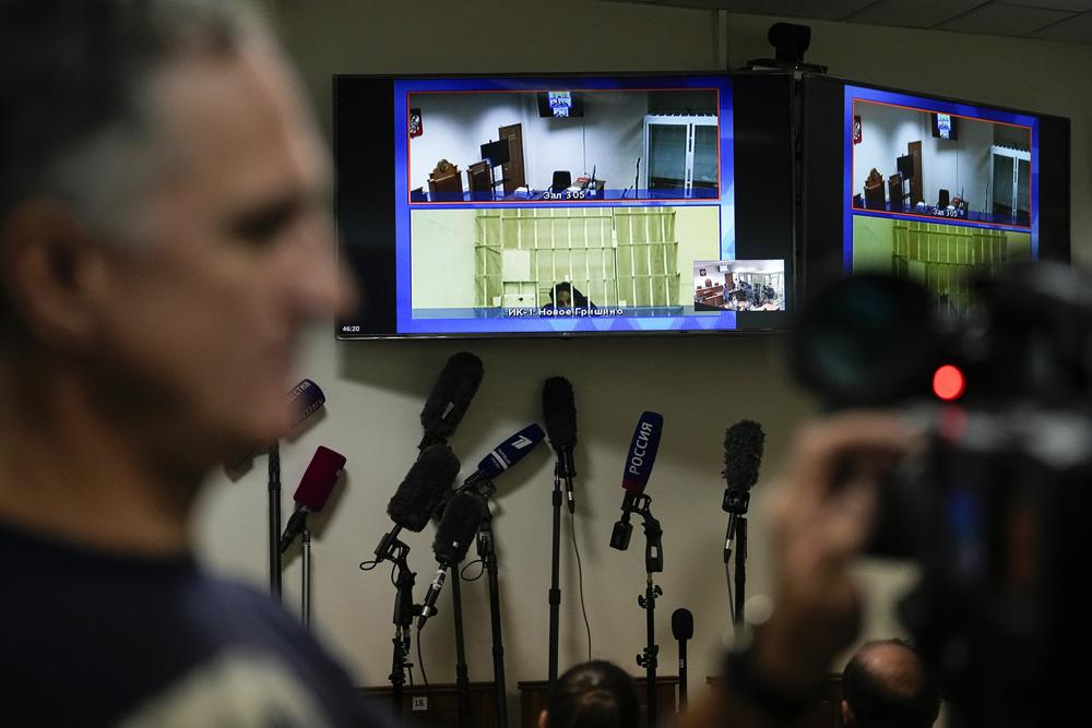 WNBA star and two-time Olympic gold medalist Brittney Griner is seen on the bottom part of a TV screen as she waits to appear in a video link provided by the Russian Federal Penitentiary Service a courtroom prior to a hearing at the Moscow Regional Court in Moscow, Russia, Tuesday, Oct. 25, 2022. A Russian court on Tuesday started hearing American basketball star Brittney Griner’s appeal against her nine-year prison sentence for drug possession. (AP Photo/Alexander Zemlianichenko)