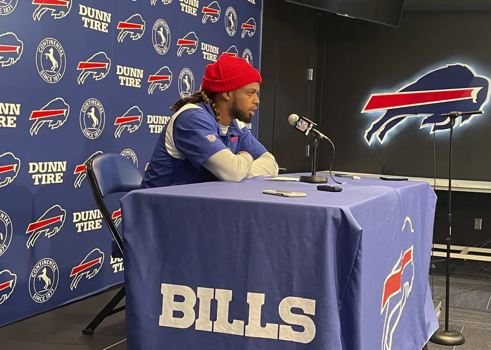 Buffalo Bills safety Damar Hamlin speaks to reporters at the NFL football team's facility in Orchard Park, N.Y., Tuesday, April 18, 2023, saying he plans to resume his football career after being cleared to play more than four months after going into cardiac arrest and needing to be resuscitated on the field during a game at Cincinnati. (AP Photo/John Wawrow)