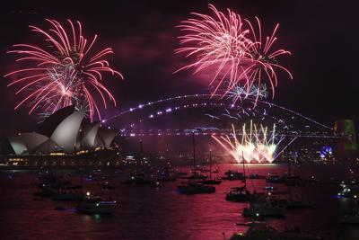 Fireworks explode over the Sydney Opera House and Harbour Bridge as New Year's Eve celebrations begin in Sydney, Friday, Dec. 31, 2021. (Dean Lewins/AAP Image via AP)