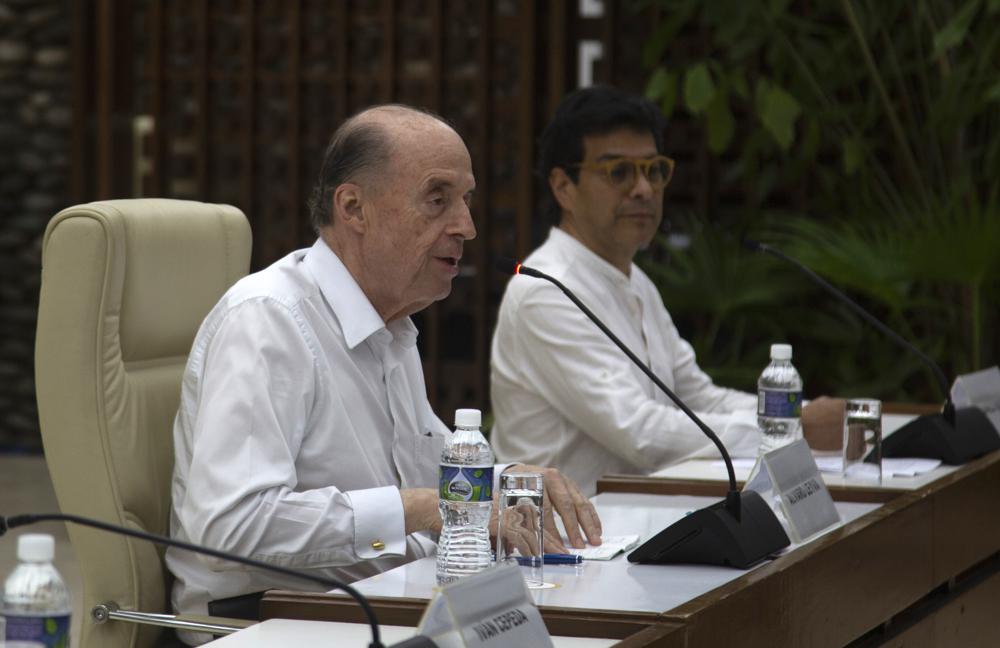 Colombian Foreign Minister Alvaro Leyva speaks as Colombian Peace Commissioner Danilo Rueda looks on during a meeting with representatives of the Colombian guerrilla National Liberation Army (ELN) in Havana, Cuba, Friday, Aug. 12, 2022. The delegations of the Colombian government and the guerrilla National Liberation Army announced on Friday that they are committed to taking the necessary steps to try to reactivate the peace negotiations suspended four years ago. (AP Photo/Ismael Francisco)