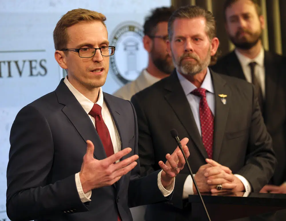 Rev. John-Mark Hart speaks as state Rep. Kevin McDugle, right, listens during a news conference. Wednesday, Feb. 22, 2023, in Oklahoma City. A group of Republican lawmakers in Oklahoma joined clergy and a former corrections official on Wednesday calling for a moratorium on the death penalty, the latest indication state officials have growing concerns about the state's brisk pace of lethal injections. (Doug Hoke/The Oklahoman via AP)