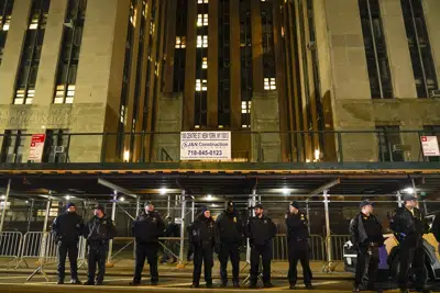 Court officers stand guard outside the Manhattan criminal courts building, Thursday, March 30, 2023, in New York. (AP Photo/Mary Altaffer)