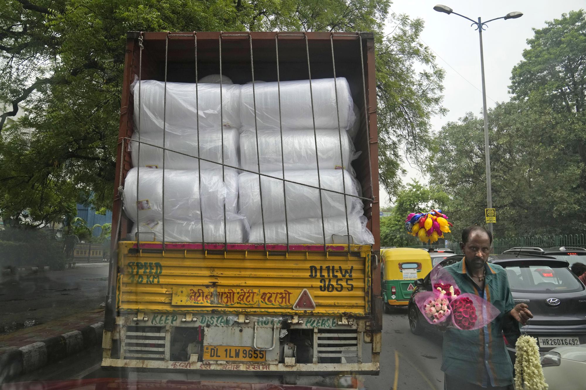 A commercial truck transports rolls of plastic used in packing in New Delhi, India, Thursday, June 30, 2022. India banned some single-use or disposable plastic products Friday as part of a federal plan to phase out the ubiquitous material in the nation of nearly 1.4 billion people. Thousands of other plastic products, like bottles for water or soda or bags of chips, aren't covered by the ban. But the federal government has set targets for manufacturers to be responsible for recycling or disposing of them after their use. (AP Photo/Manish Swarup)