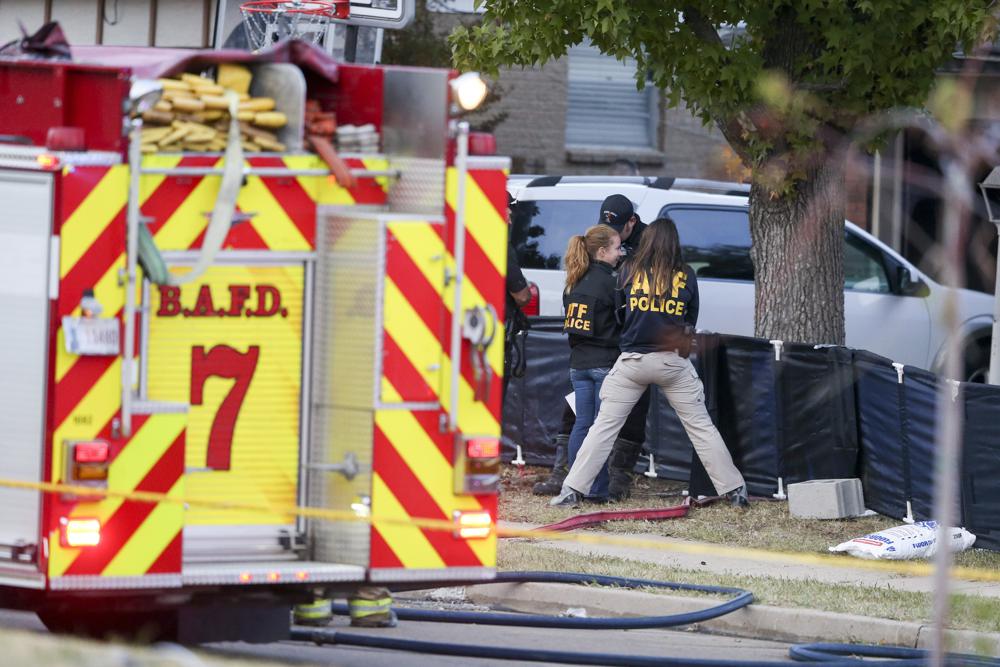 Broken Arrow, Okla., police and fire department investigate the scene of a fire with multiple fatalities at the corner South Hickory Ave. and West Galveston St. on Thursday, Oct. 27, 2022. Eight people were found dead Thursday after a fire was extinguished at a Tulsa-area house, and police said they were investigating the deaths as homicides. (Ian Maule/Tulsa World via AP)