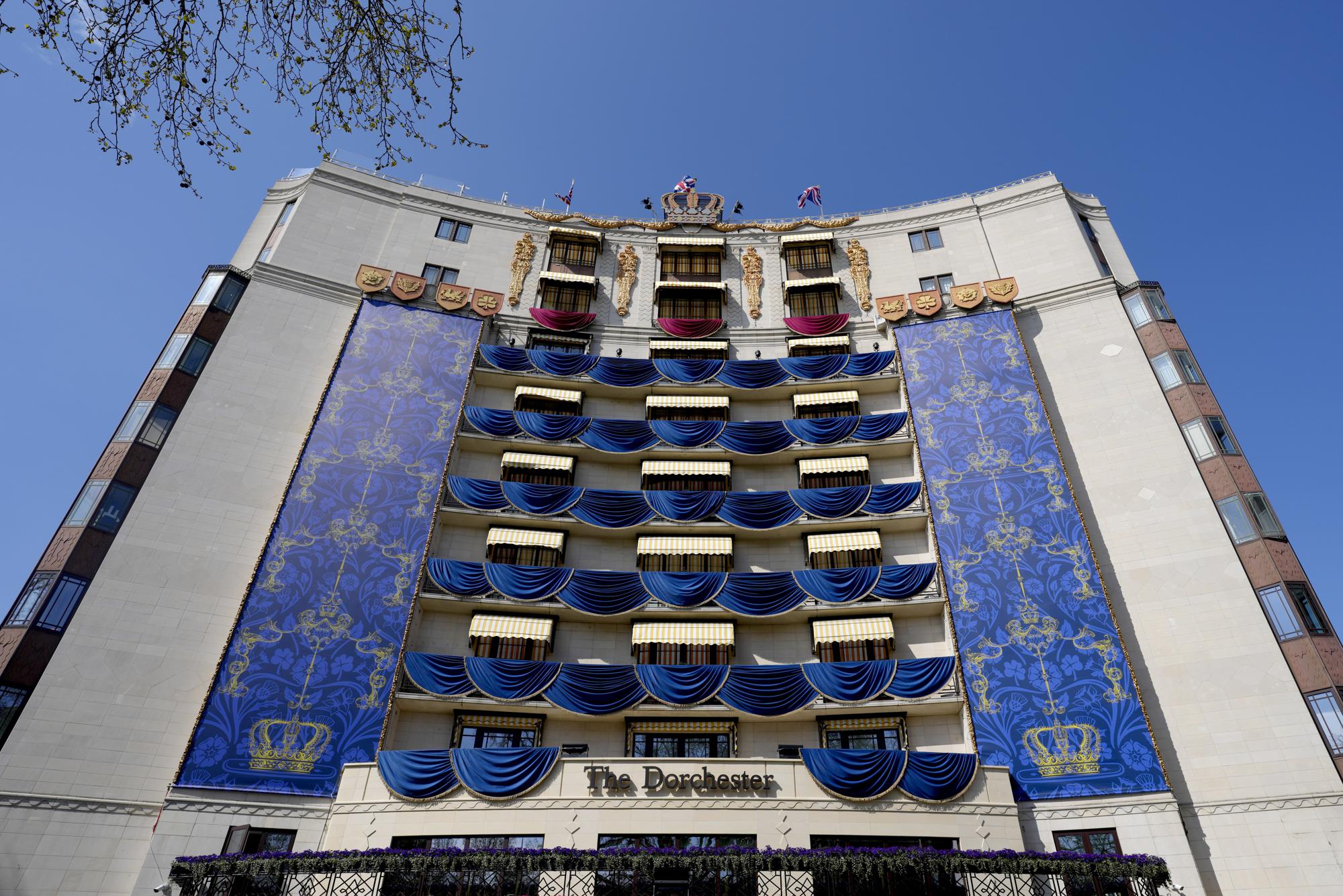 A facade mimicking the 1953 Coronation decor by Oliver Messel, decorates the Dorchester Hotel in London, Thursday, April 20, 2023. The Dorchester Hotel, long a favorite with royals and celebrities, concocted a lavish, five-tier coronation cake and put up theater-style draping across its facade to re-create the decorations that it used to mark Queen Elizabeth II’s coronation in 1953 in preparation for King Charles III's coronation on May 6. (AP Photo/Kirsty Wigglesworth)
